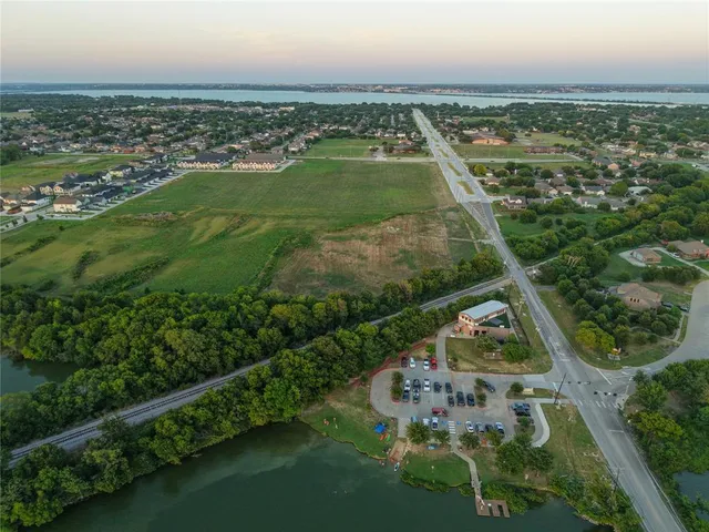 an aerial view of residential houses with outdoor space and river