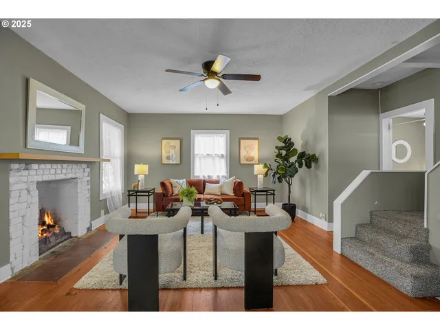 a living room with furniture a fireplace and a potted plant