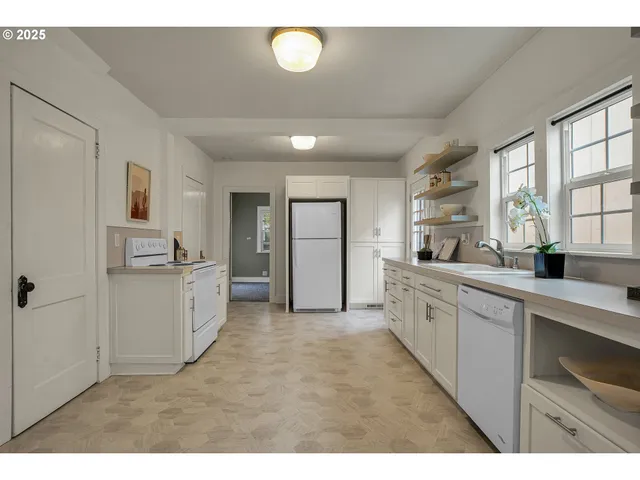 a kitchen with refrigerator and window