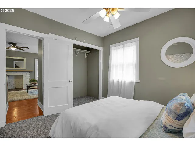 a bedroom with a bed and a painting on the wall