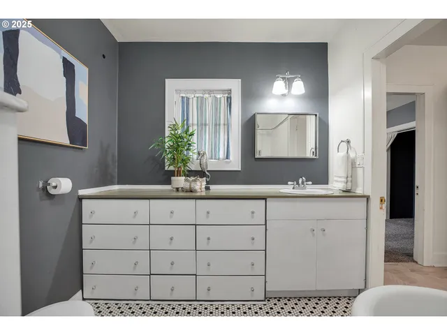 a bathroom with a toilet sink and mirror