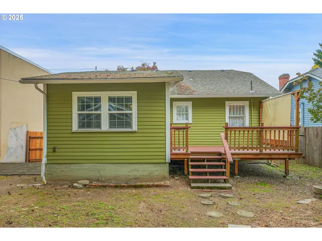 a backyard of a house with barbeque oven table and chairs