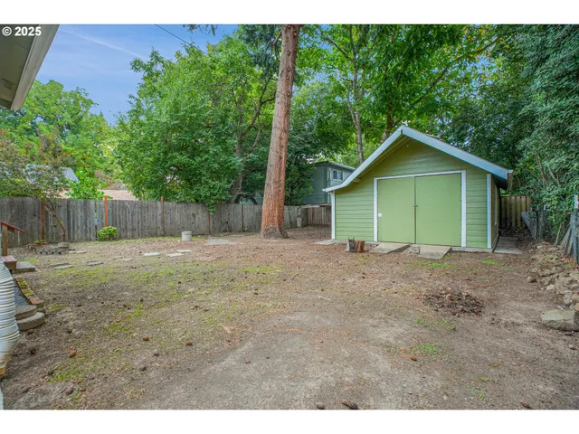 a view of a house with a backyard