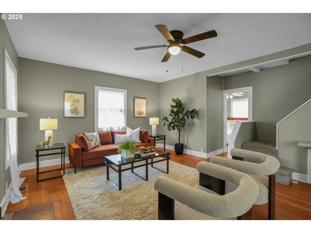 a living room with furniture and a wooden floor
