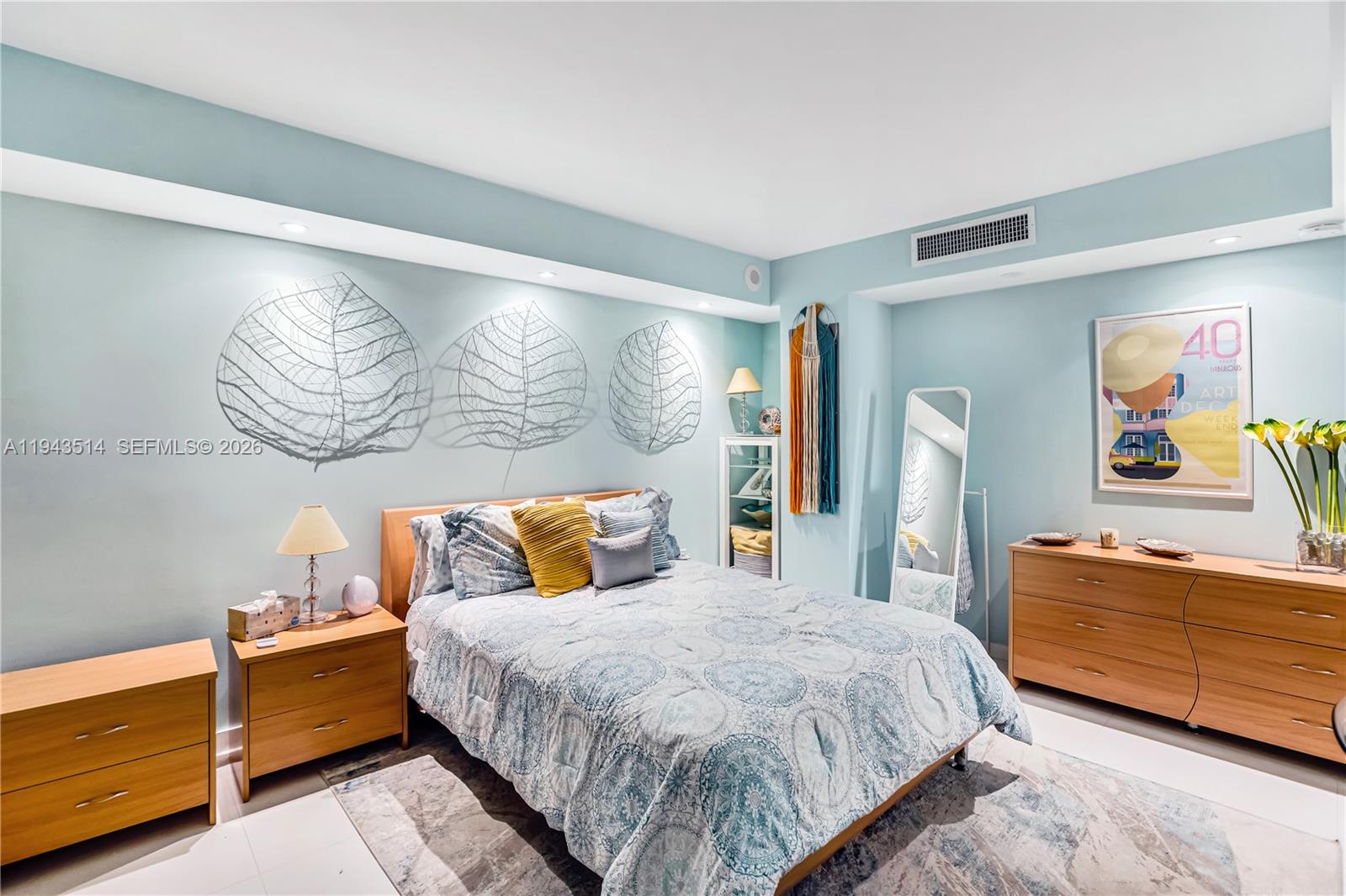 10155 Collins Avenue, Unit 606 Bal Harbour, FL 33154 - Photo 24 of 48 a bedroom with a bed and a dresser