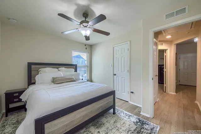 a bedroom with a large bed and a chandelier