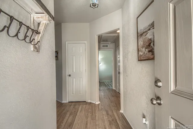 a view of an entryway with wooden floor