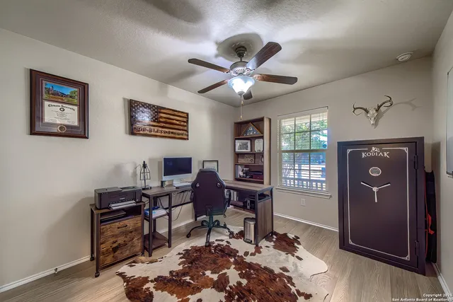 a view of a workspace with furniture and a window