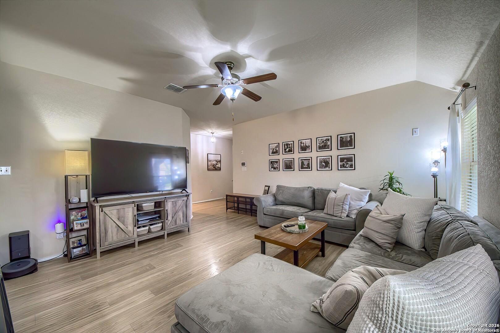 200 Stetson Street Cibolo, TX 78108 - Photo 2 of 28 a living room with furniture and a flat screen tv