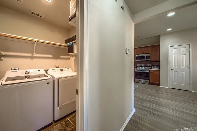 a view of storage and utility room with wooden floor