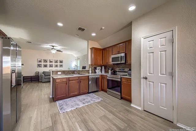 a kitchen with refrigerator and cabinets