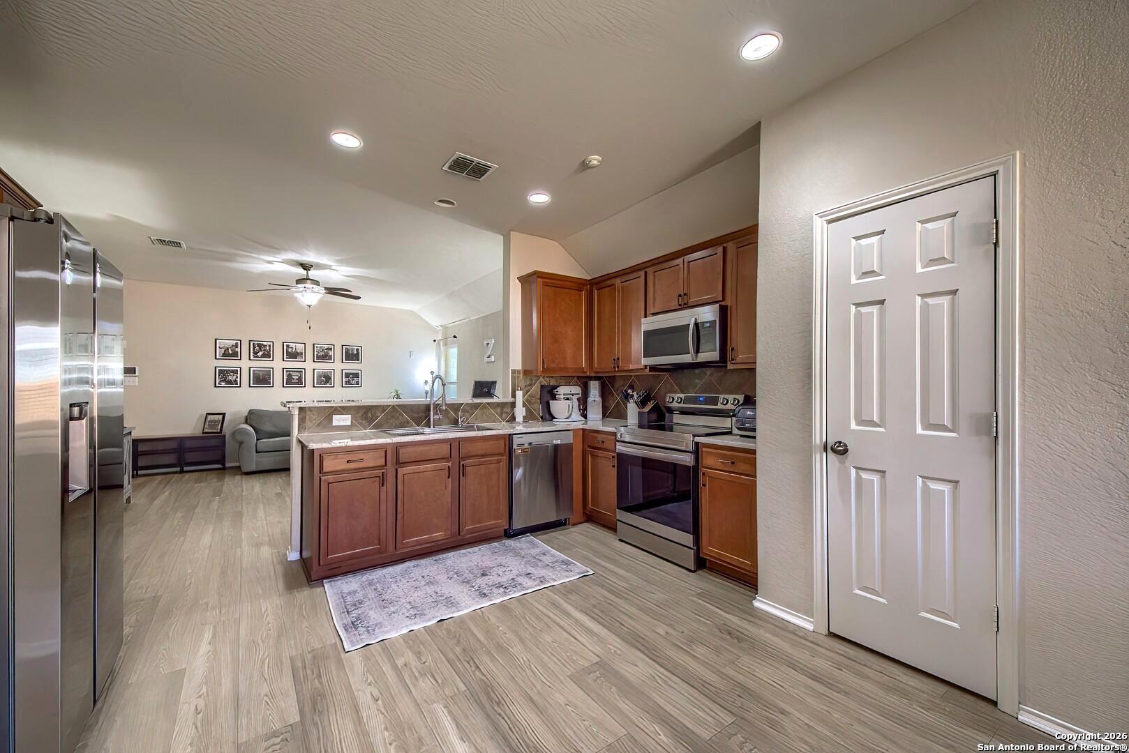 200 Stetson Street Cibolo, TX 78108 - Photo 5 of 28 a kitchen with refrigerator and cabinets