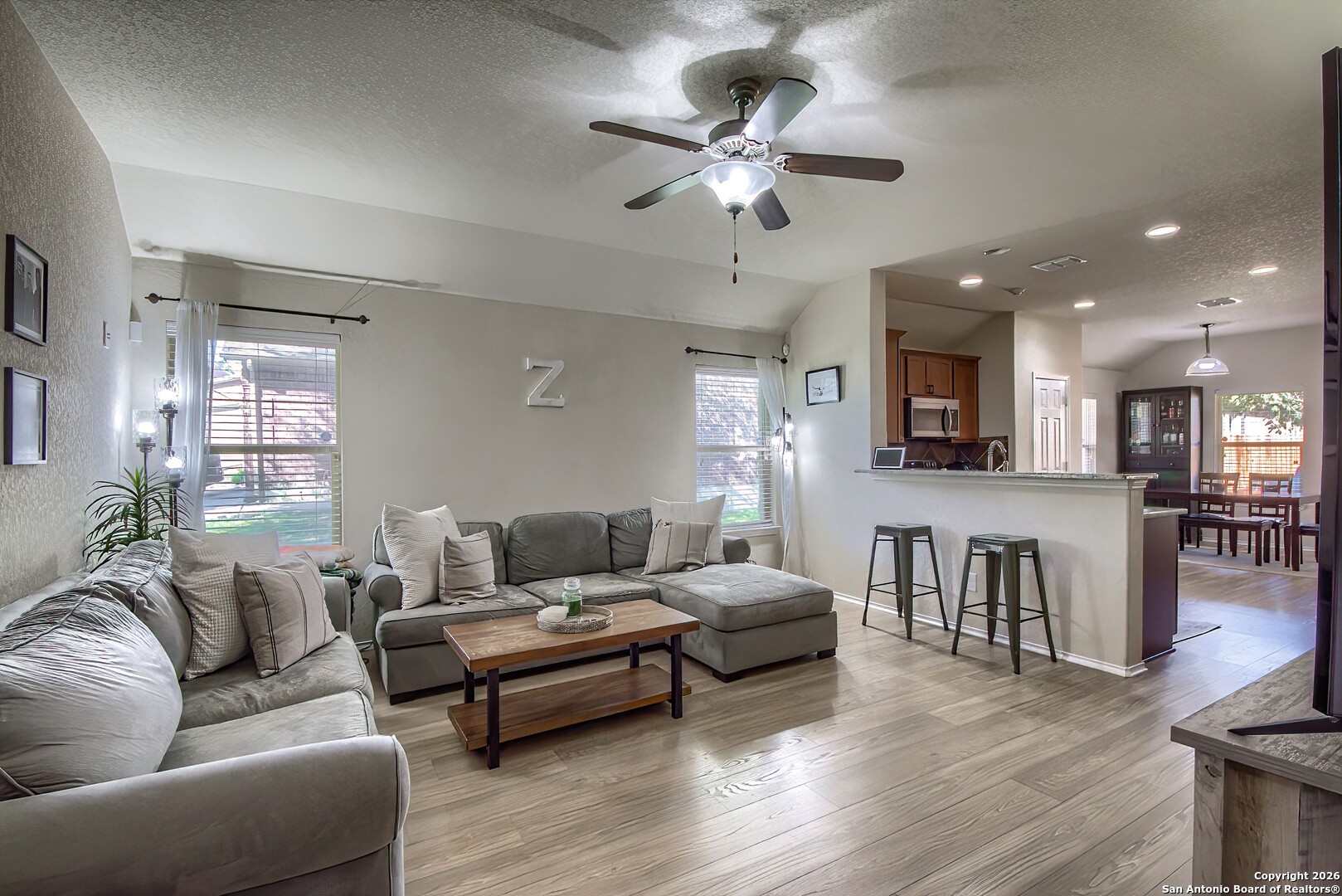 200 Stetson Street Cibolo, TX 78108 - Photo 7 of 28 a living room with furniture kitchen view and a wooden floor