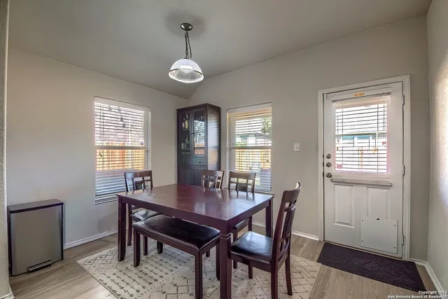 a view of a dining room with furniture window and wooden floor