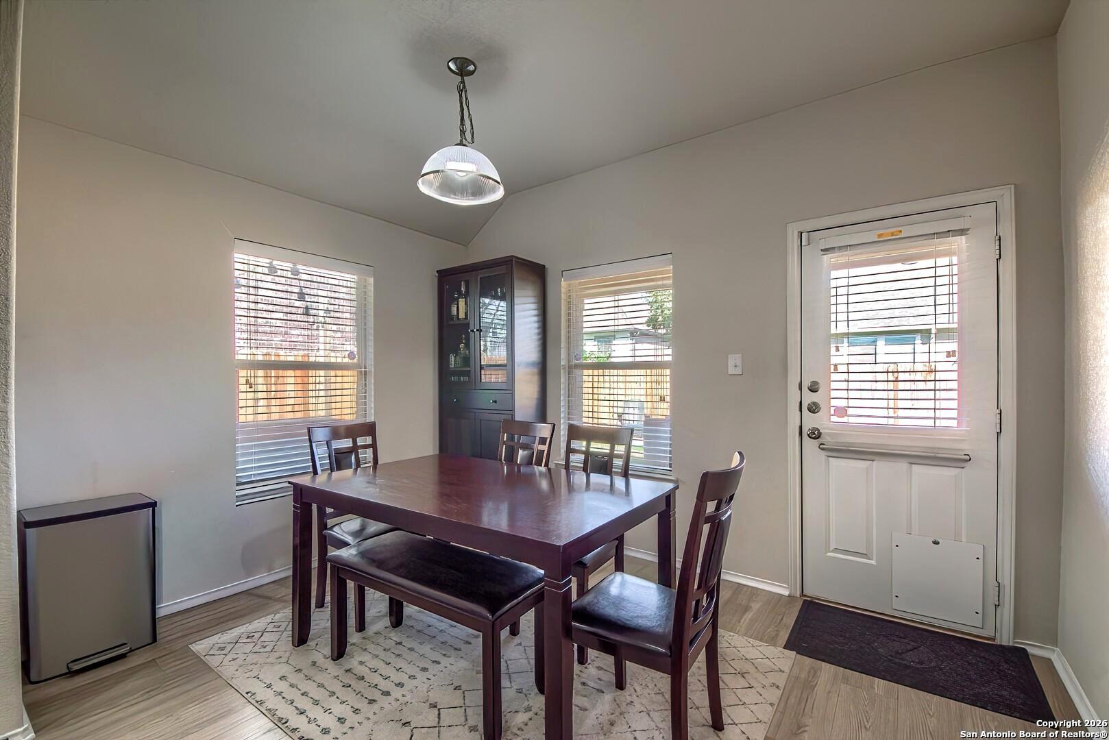 200 Stetson Street Cibolo, TX 78108 - Photo 8 of 28 a view of a dining room with furniture window and wooden floor
