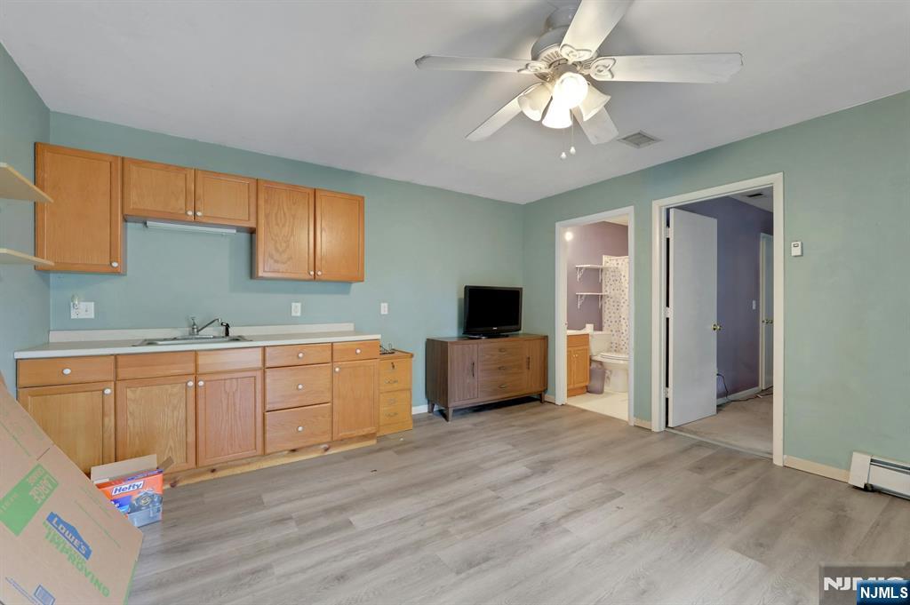 17 Butler Place Wanaque, NJ 07420 - Photo 9 of 28 a kitchen with stainless steel appliances granite countertop a sink cabinets and wooden floor