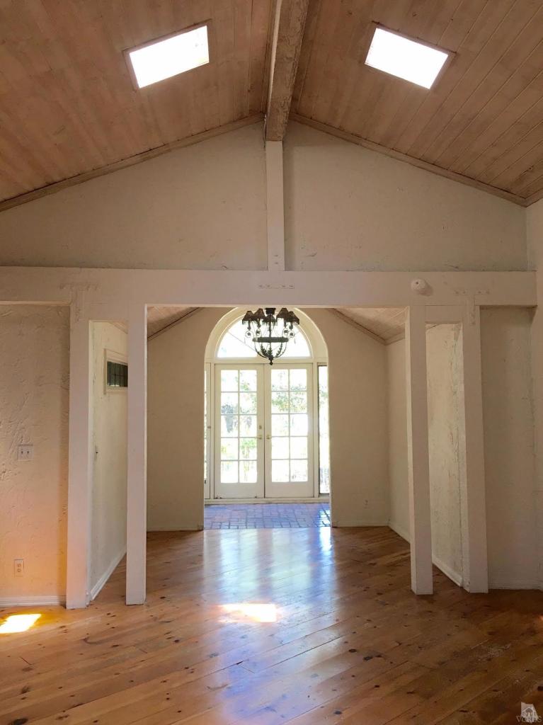 212 Dirt Road Lake Sherwood, CA 91361 - Photo 2 of 41 an empty room with wooden floor and windows