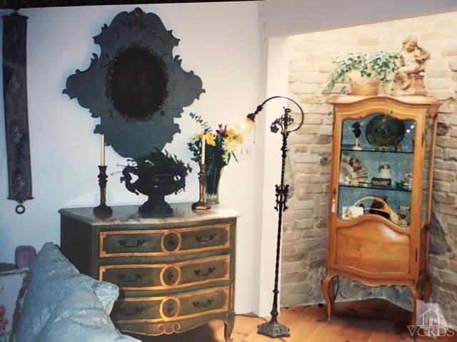 212 Dirt Road Lake Sherwood, CA 91361 - Photo 28 of 41 a room with a chandelier and a wooden floor