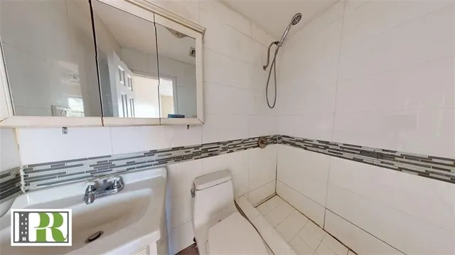 a bathroom with a sink a mirror and a shower