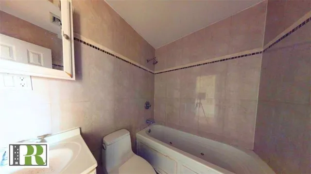 a bathroom with a bathtub and shower