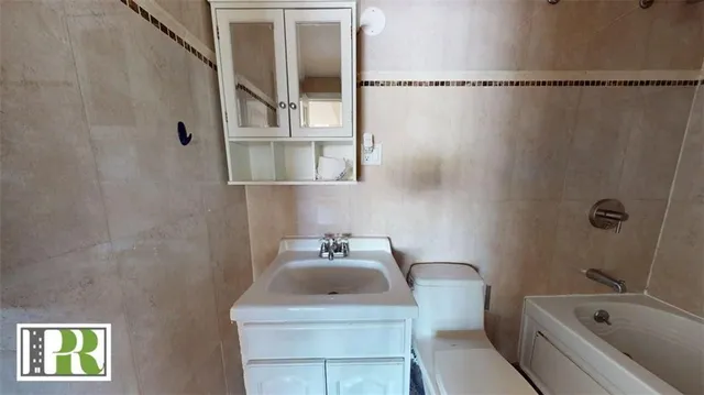 a bathroom with a sink a window and a shower