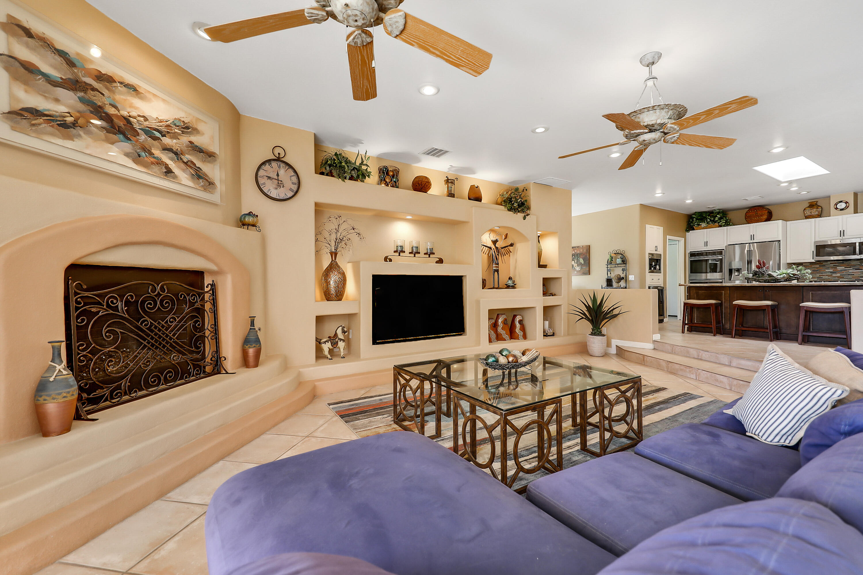 72447 Magnesia Falls Drive Rancho Mirage, CA 92270 - Photo 11 of 50 a living room with furniture a flat screen tv and a fireplace