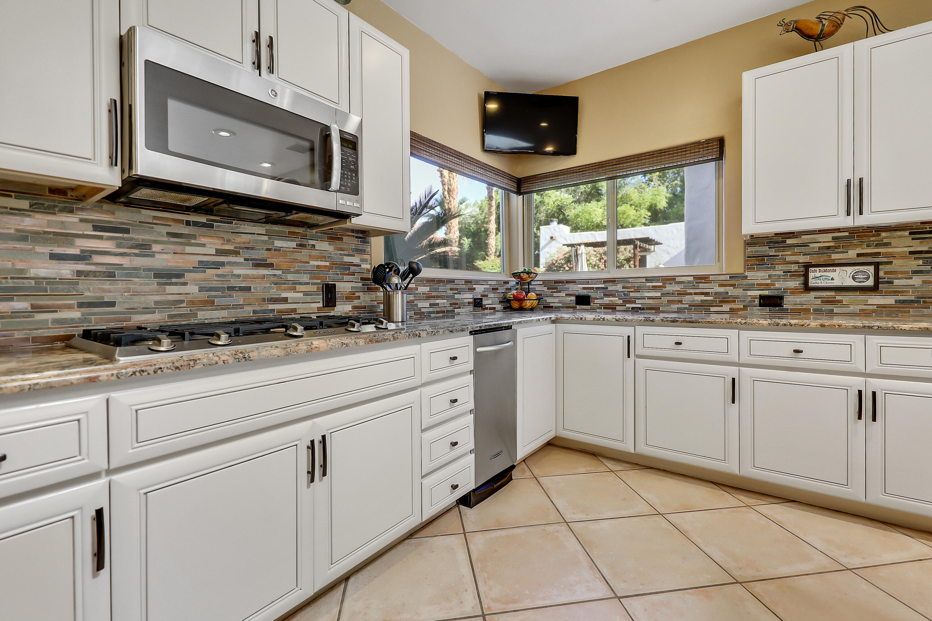 72447 Magnesia Falls Drive Rancho Mirage, CA 92270 - Photo 17 of 50 a kitchen with appliances cabinets and a sink
