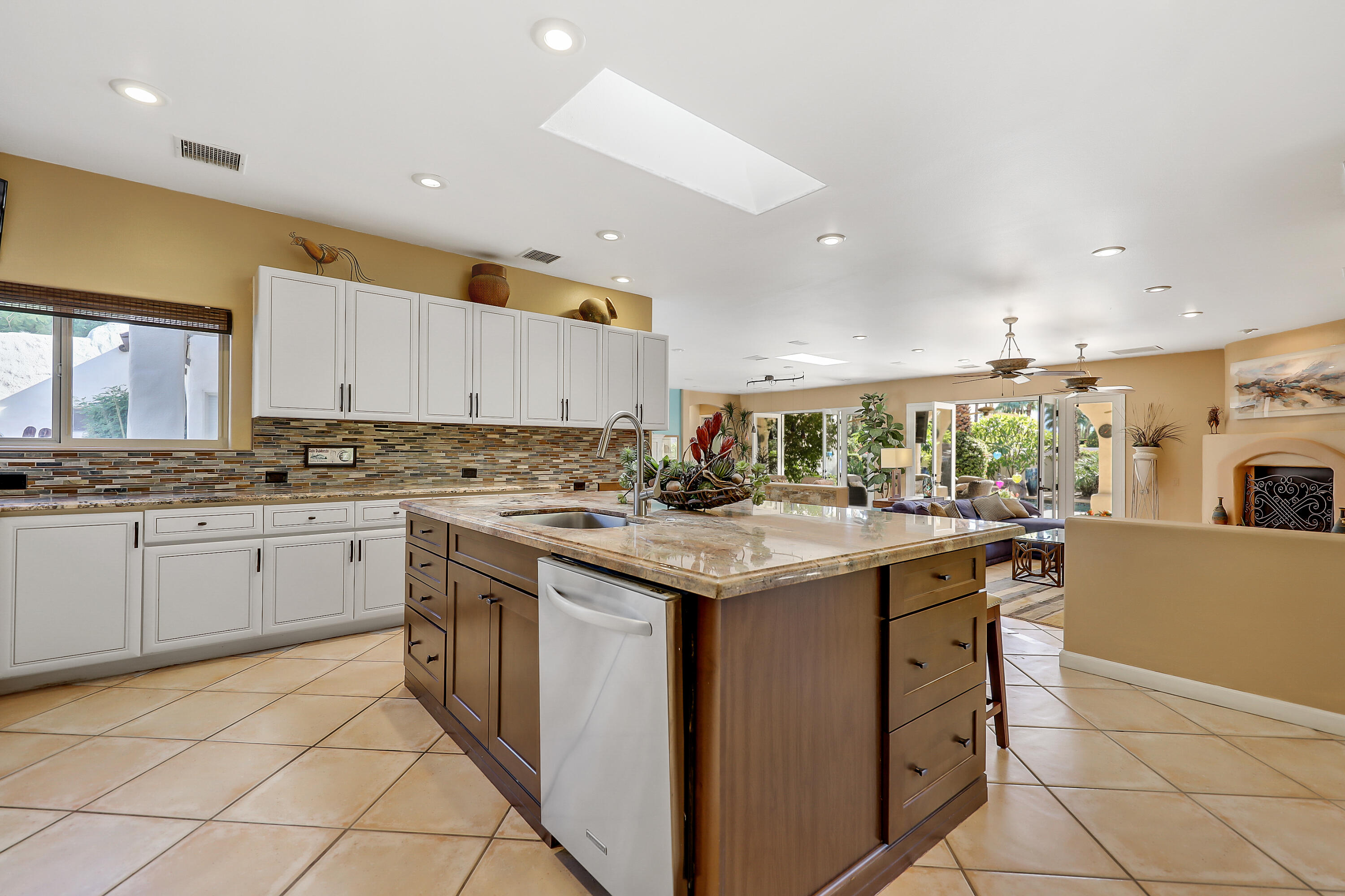 72447 Magnesia Falls Drive Rancho Mirage, CA 92270 - Photo 18 of 50 a kitchen with granite countertop a sink and cabinets