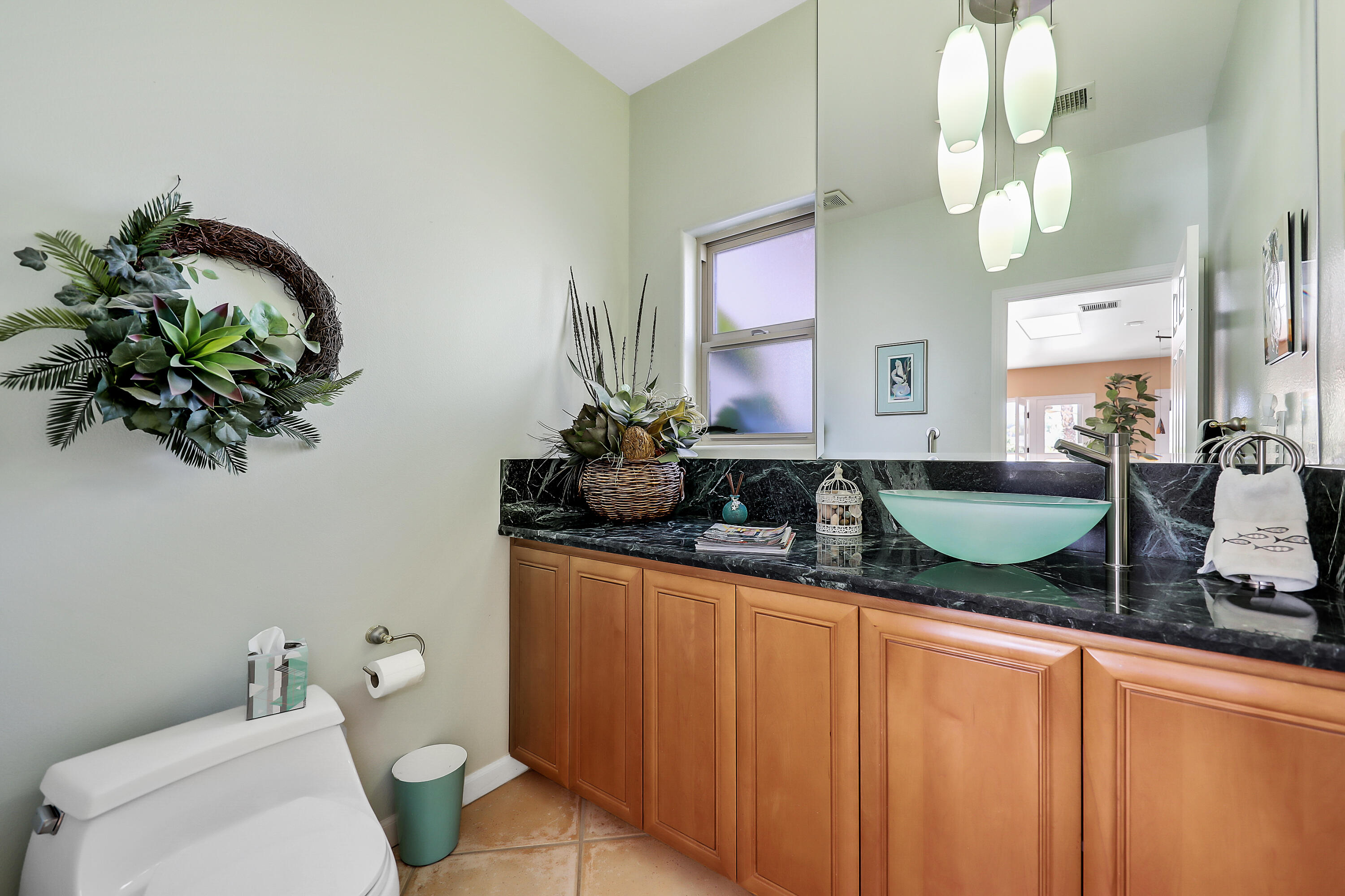 72447 Magnesia Falls Drive Rancho Mirage, CA 92270 - Photo 20 of 50 a bathroom with a granite countertop sink a toilet and a mirror