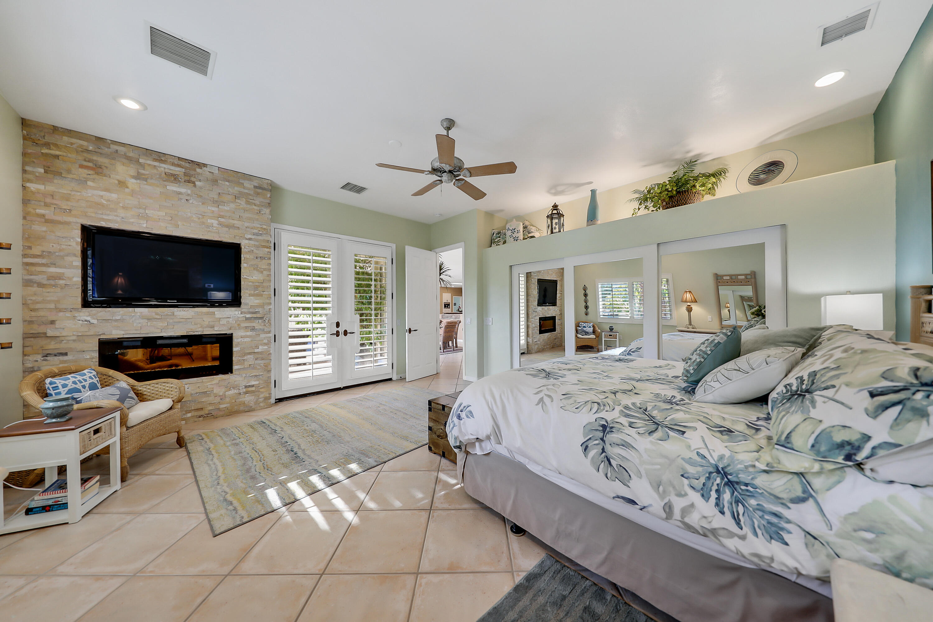 72447 Magnesia Falls Drive Rancho Mirage, CA 92270 - Photo 22 of 50 a bedroom with a bed and a flat screen tv
