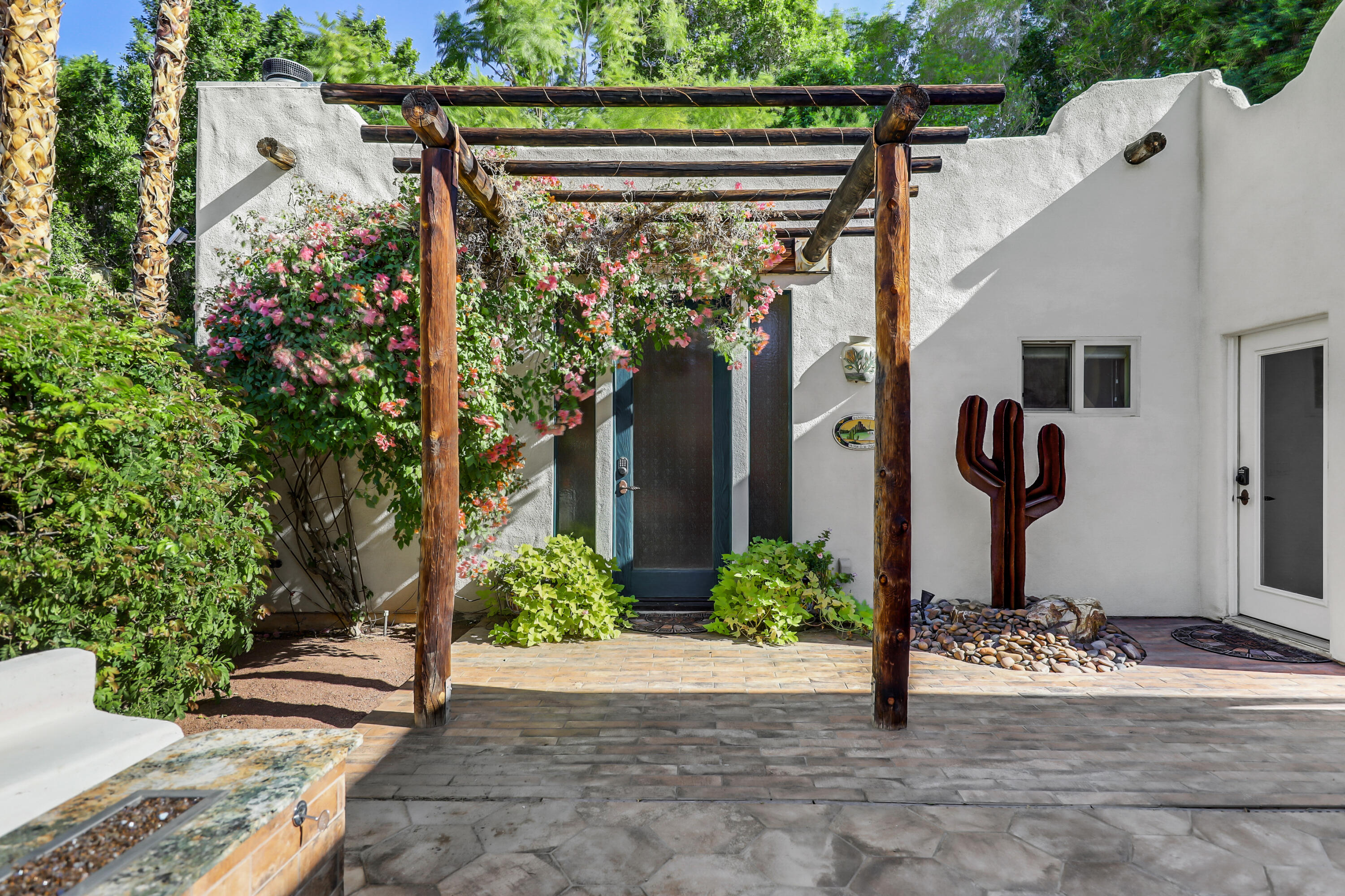 72447 Magnesia Falls Drive Rancho Mirage, CA 92270 - Photo 30 of 50 a front view of a house with garden