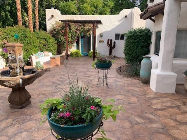 72447 Magnesia Falls Drive Rancho Mirage, CA 92270 - Photo 3 of 50 a view of a patio with table and chairs potted plants