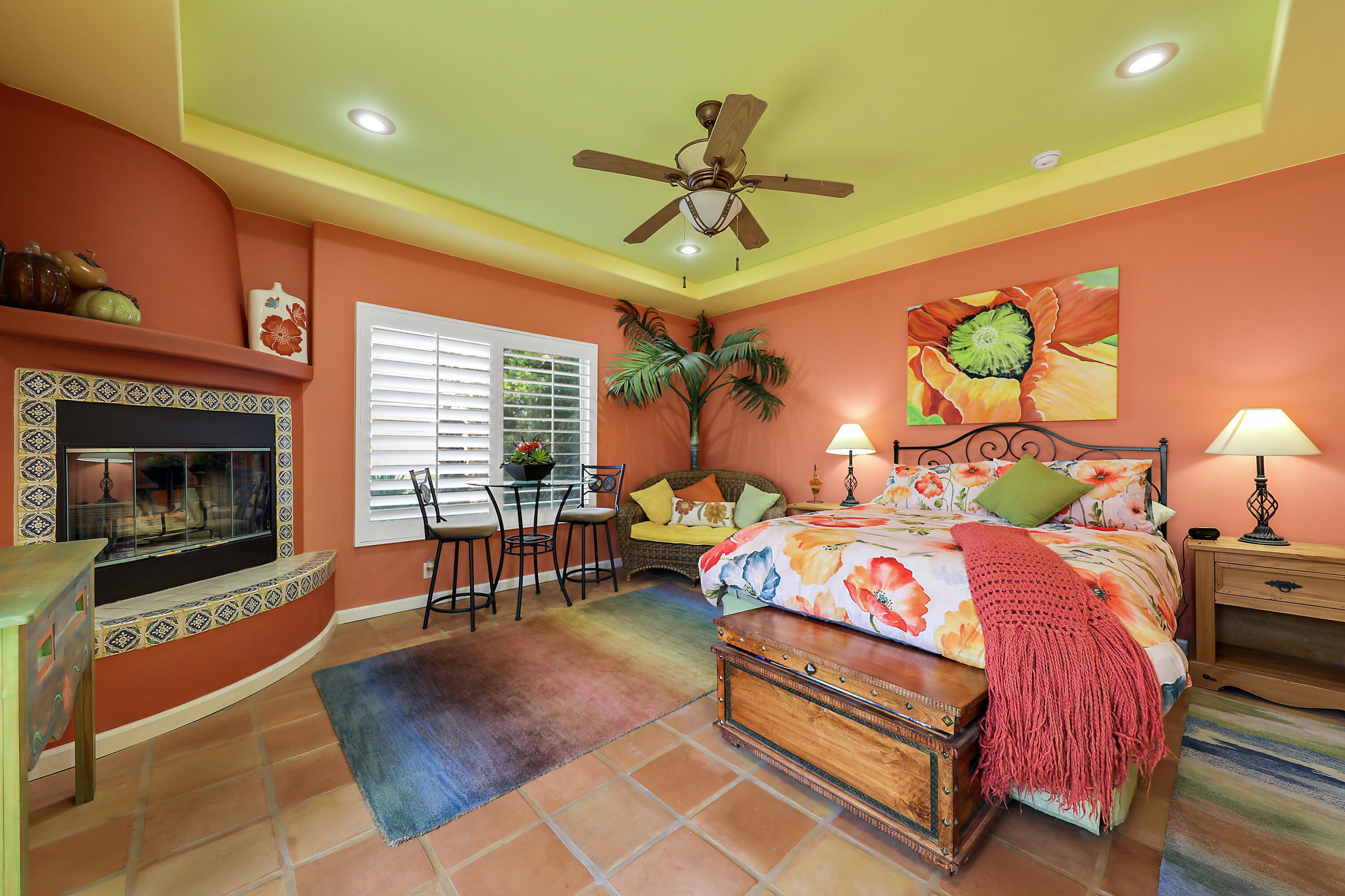 72447 Magnesia Falls Drive Rancho Mirage, CA 92270 - Photo 31 of 50 a bedroom with a bed a chandelier and a fireplace