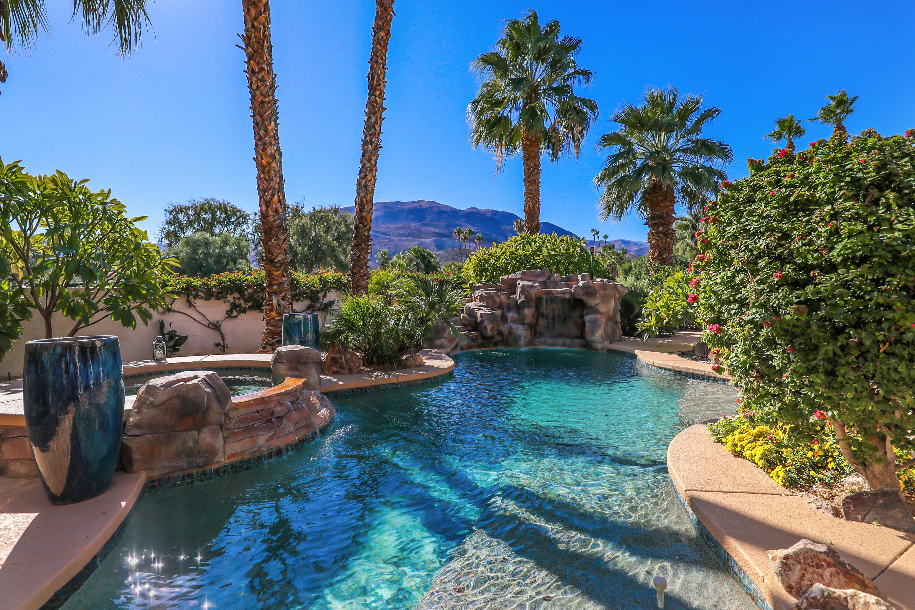 72447 Magnesia Falls Drive Rancho Mirage, CA 92270 - Photo 38 of 50 a view of a backyard with plants and a patio