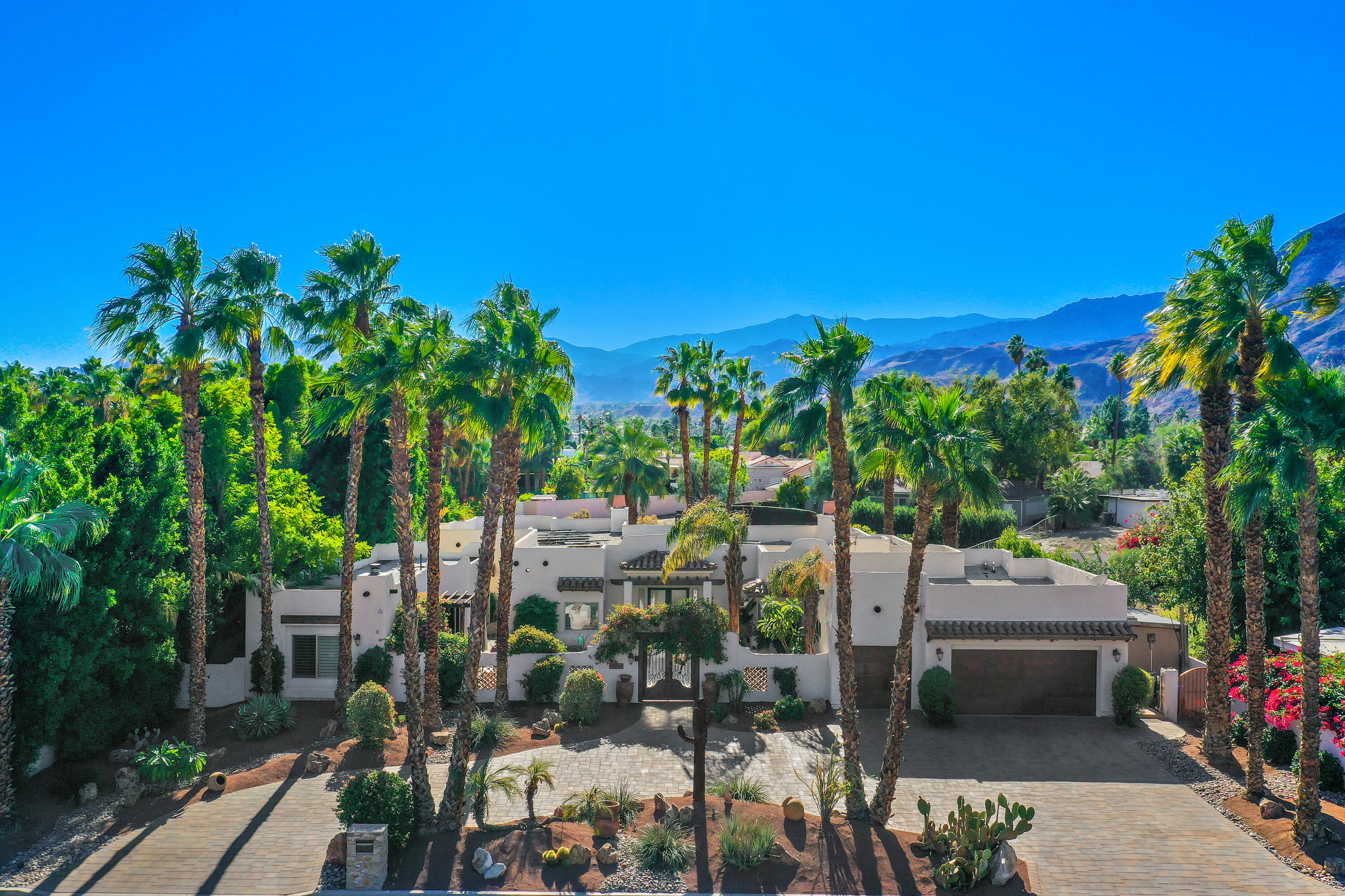 72447 Magnesia Falls Drive Rancho Mirage, CA 92270 - Photo 47 of 50 a view of a patio with table and chairs and potted plants