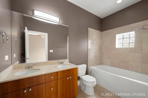 a bathroom with a sink a toilet a tub and shower