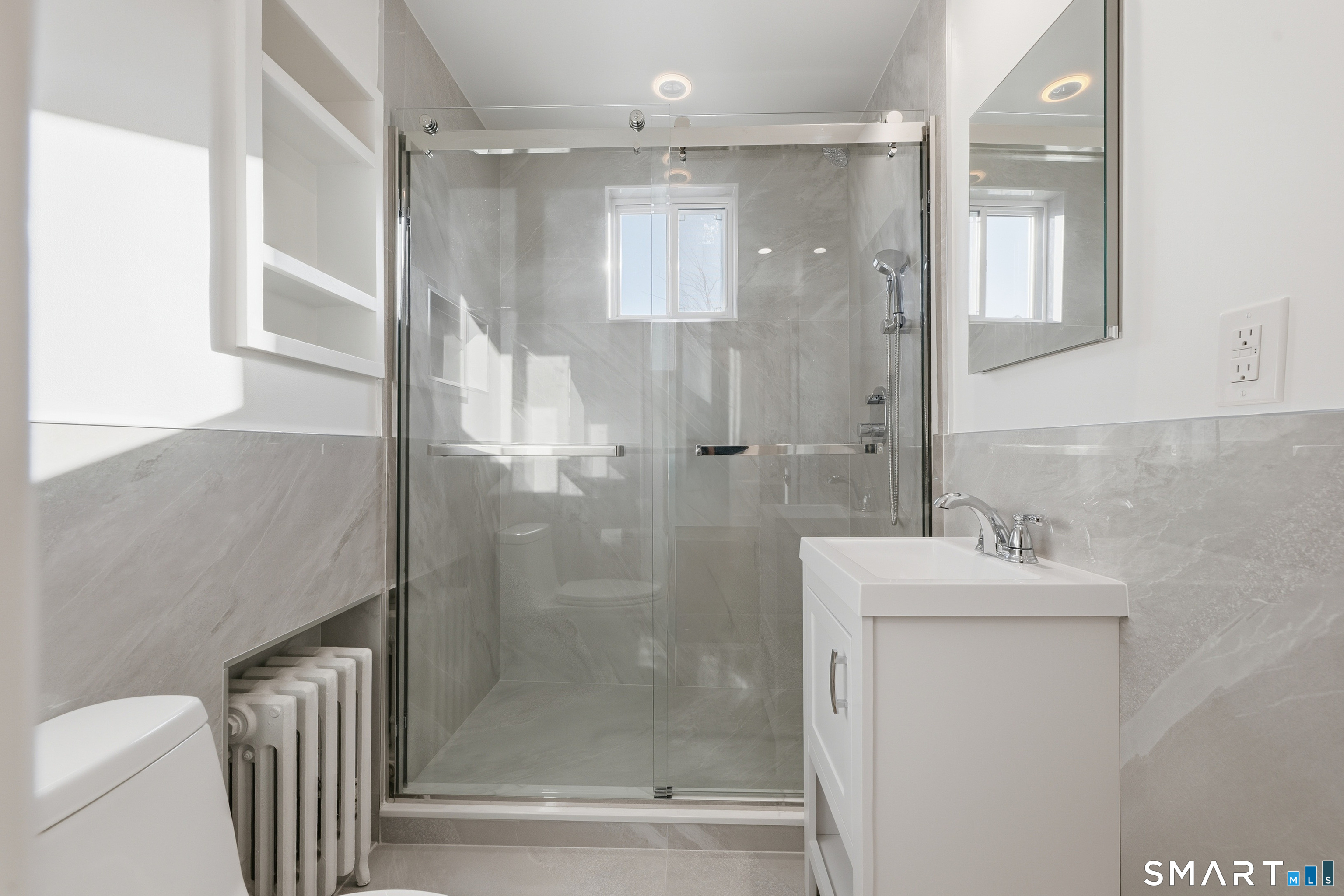 44 Lorraine Terrace, Unit 2 Bridgeport, CT 06604 - Photo 13 of 16 a bathroom with a shower a mirror and a sink