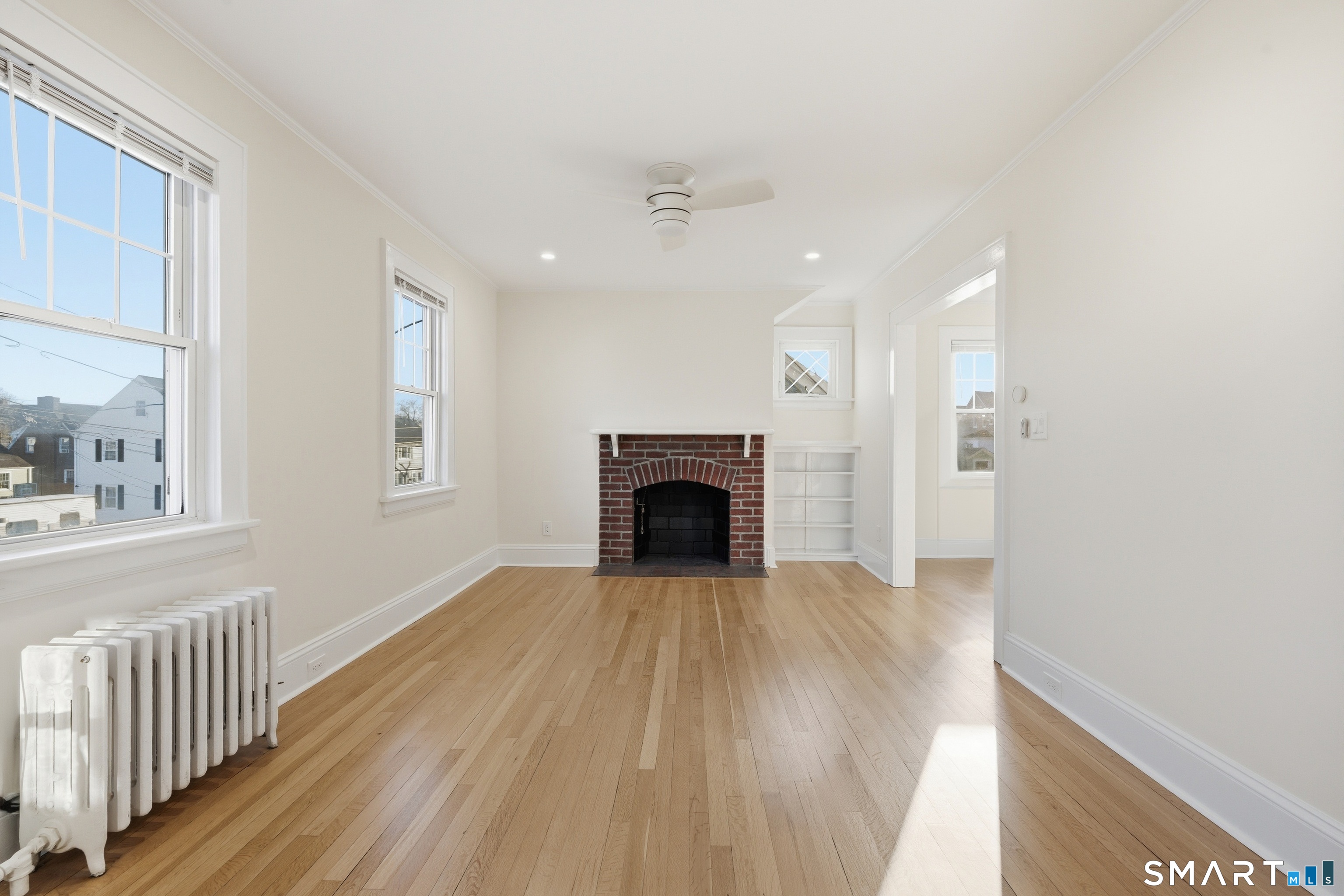 44 Lorraine Terrace, Unit 2 Bridgeport, CT 06604 - Photo 2 of 16 wooden floor fireplace and windows in an empty room