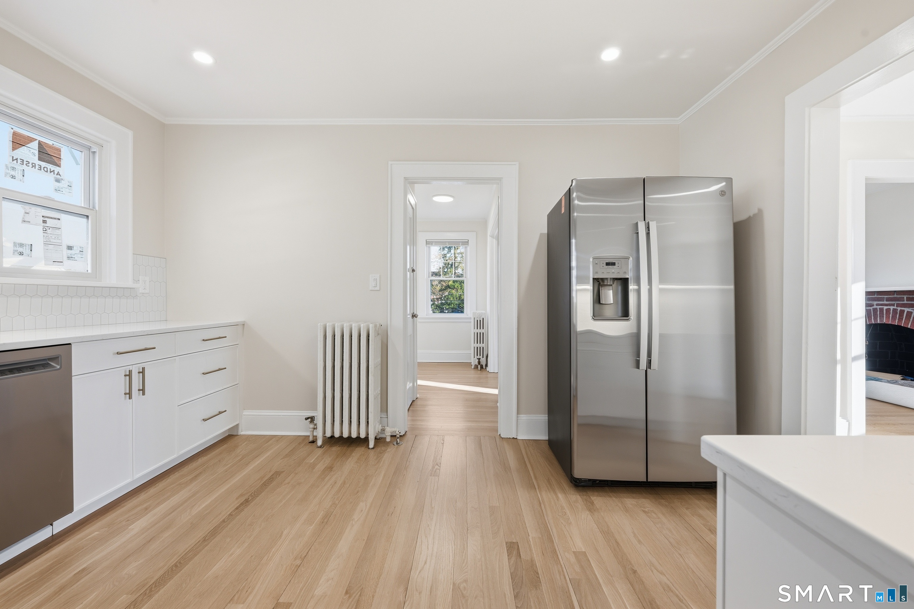 44 Lorraine Terrace, Unit 2 Bridgeport, CT 06604 - Photo 7 of 16 a hallway view with wooden floor and windows