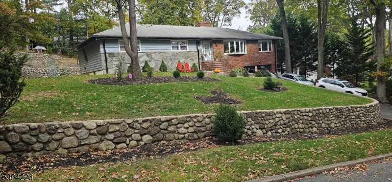 11 Surrey Place, Unit 1 Hawthorne, NJ 07506 - Photo 1 of 13 a front view of a house with a yard