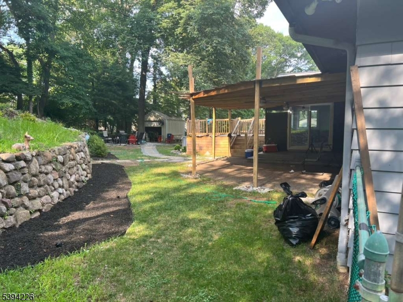 11 Surrey Place, Unit 1 Hawthorne, NJ 07506 - Photo 11 of 13 a view of a chair and table in backyard