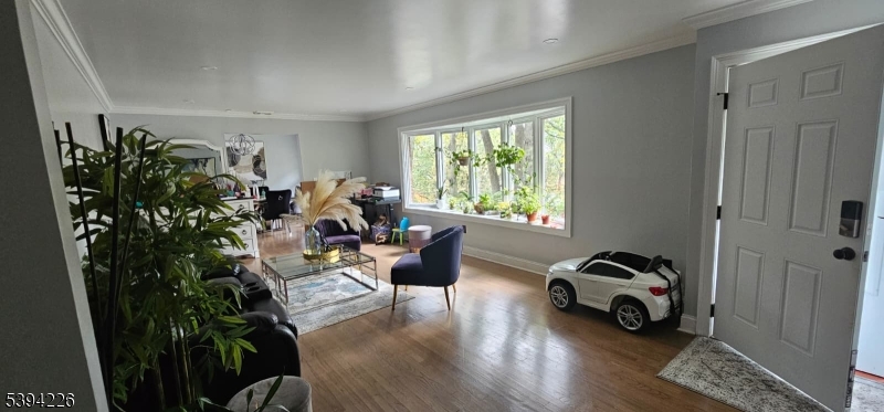 11 Surrey Place, Unit 1 Hawthorne, NJ 07506 - Photo 5 of 13 a living room with furniture and a window