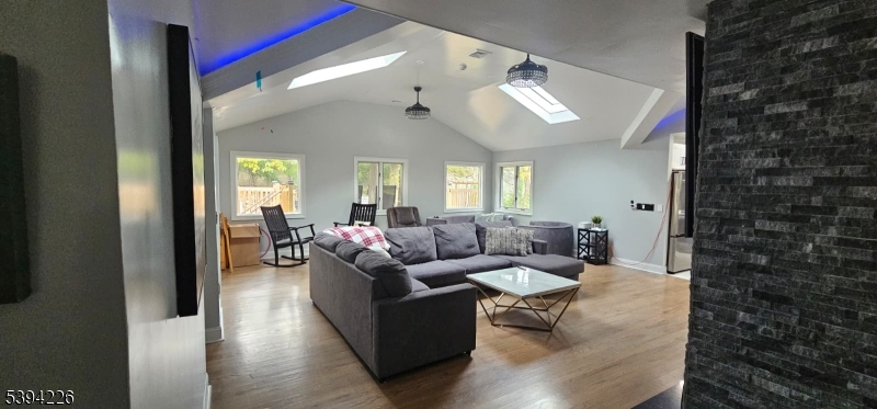 11 Surrey Place, Unit 1 Hawthorne, NJ 07506 - Photo 6 of 13 a living room with furniture and wooden floor