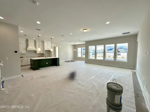 an aerial view of a swimming pool with outdoor seating