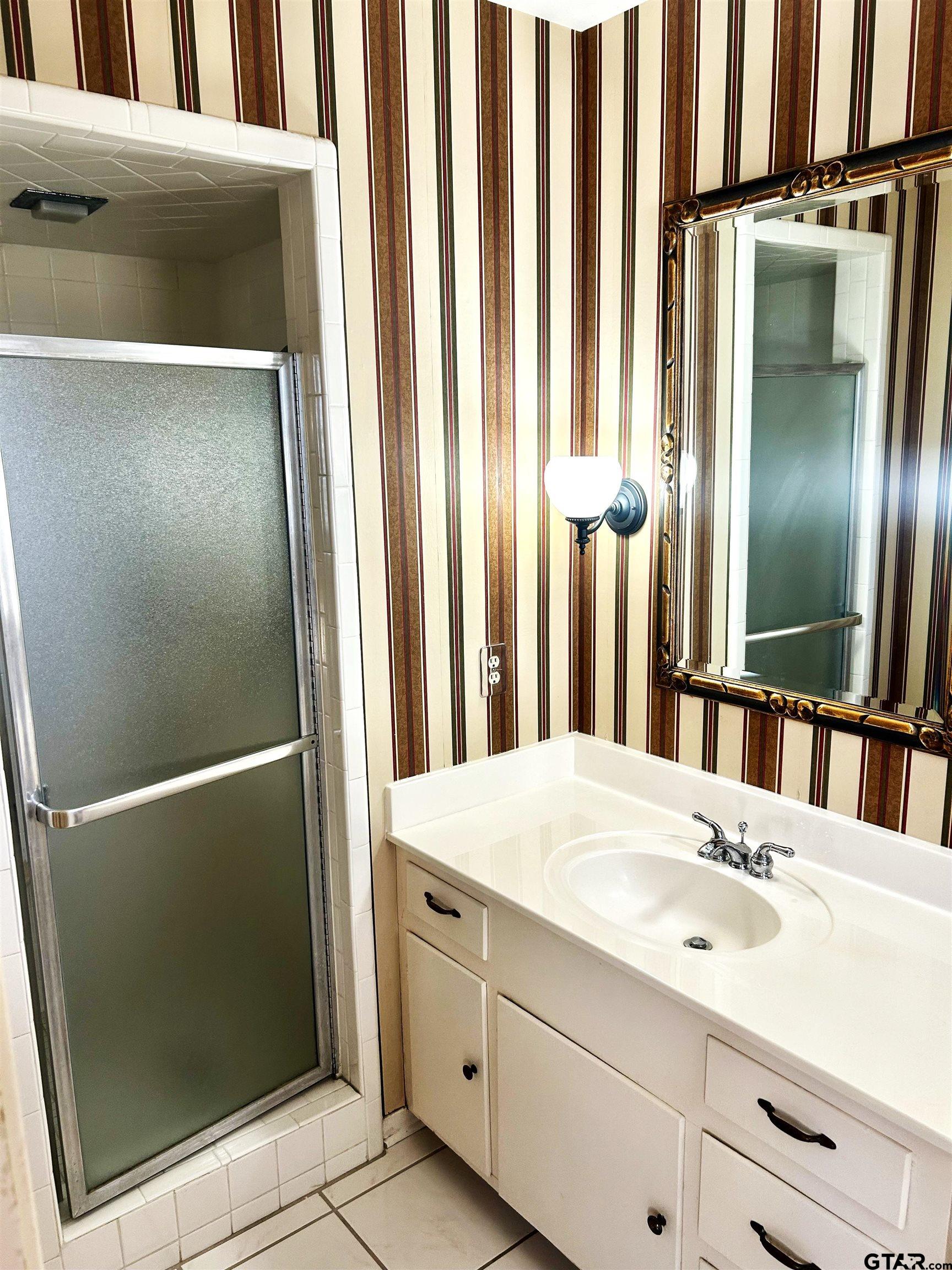3713 Colgate Avenue Tyler, TX 75701 - Photo 11 of 13 a bathroom with a sink and a mirror