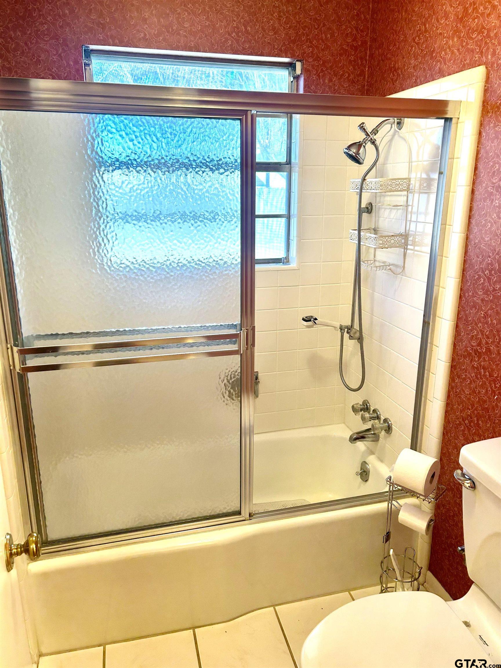 3713 Colgate Avenue Tyler, TX 75701 - Photo 10 of 13 a bathroom with a bathtub and a shower