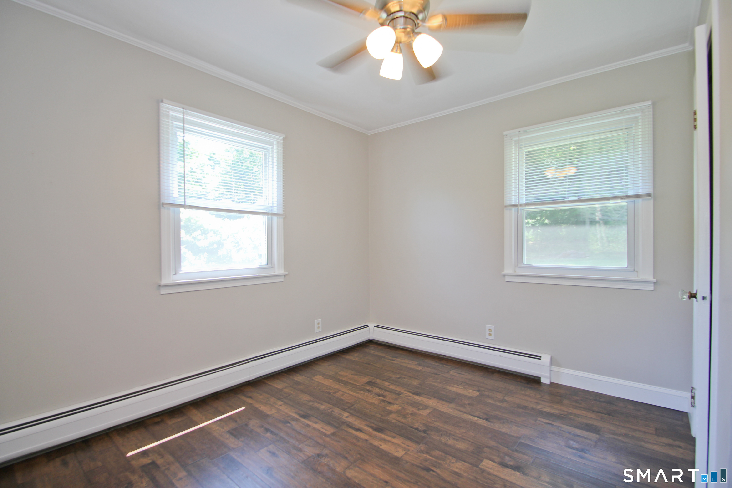 5 R Broad Hill Road Granby, CT 06090 - Photo 19 of 31 a view of an empty room with wooden floor and a window