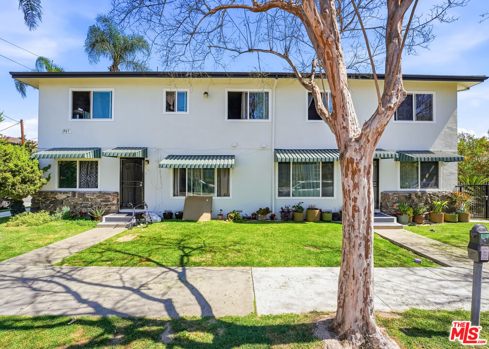 1027 North Parton Street Santa Ana, CA 92701 - Photo 2 of 7 a view of a brick house with a yard in front of a house
