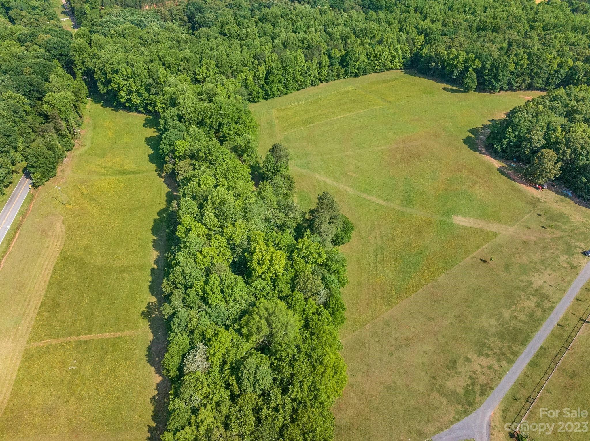0 Grassy Pond Road Gaffney, SC 29341 - Photo 2 of 20 a blue swimming pool is in front of a big yard of house