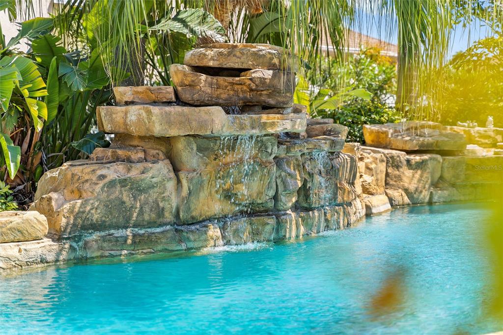 725 Monte Cristo Boulevard Tierra Verde, FL 33715 - Photo 12 of 63 a backyard of a house with table and chairs